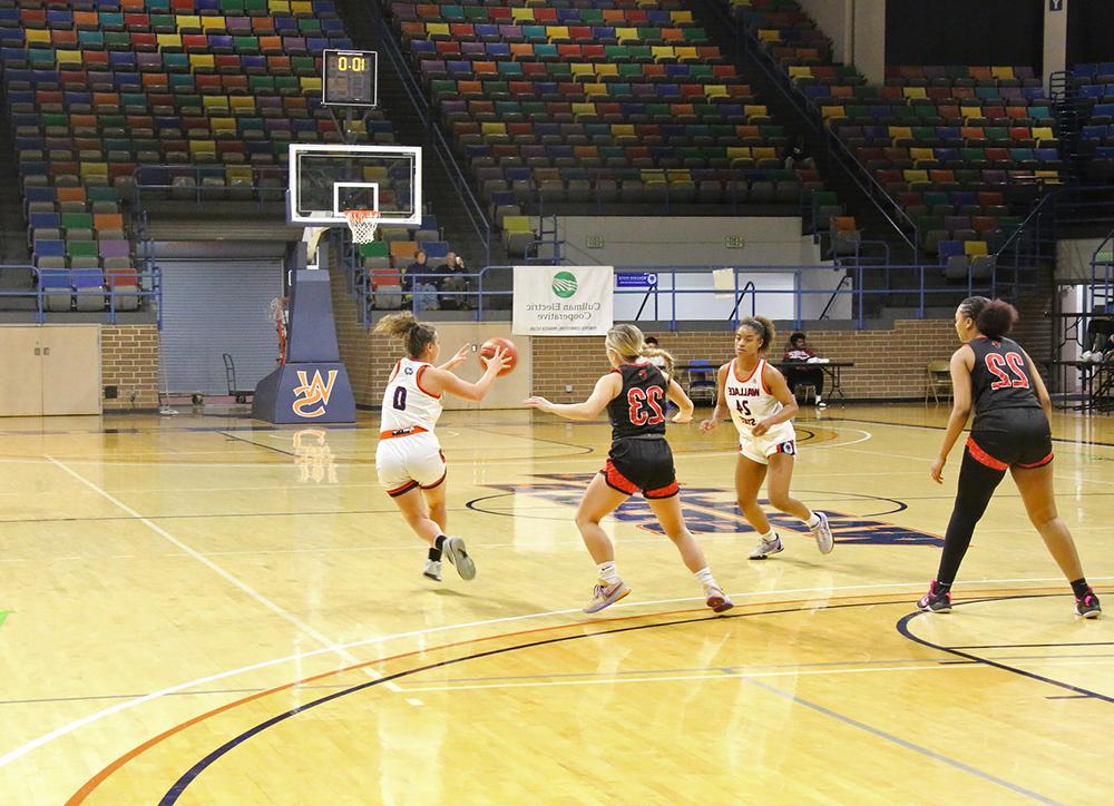 Nylaa Fuller (24) makes a pass to Kallie Tinker (0)
