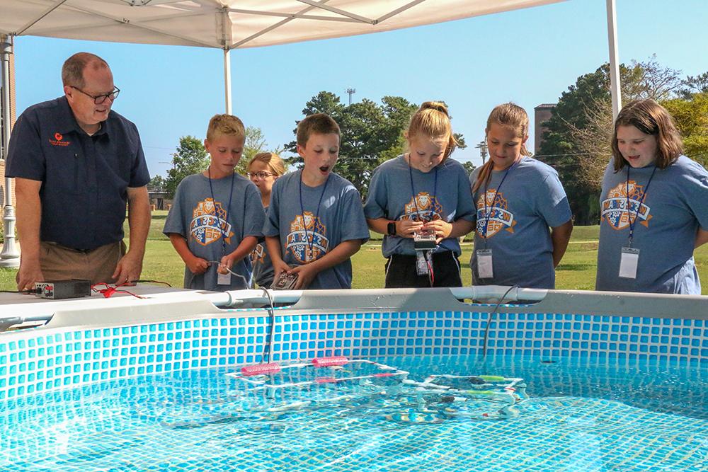 Computer Science Department Chair Terry Ayers leads an underwater robotics activity.